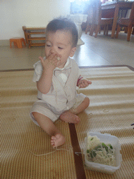 Max eating noodles for his first birthday in the apartment of Miaomiao`s parents