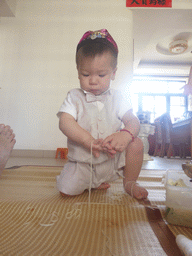 Max eating noodles for his first birthday in the apartment of Miaomiao`s parents