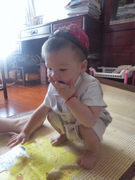 Max eating noodles for his first birthday in the apartment of Miaomiao`s parents