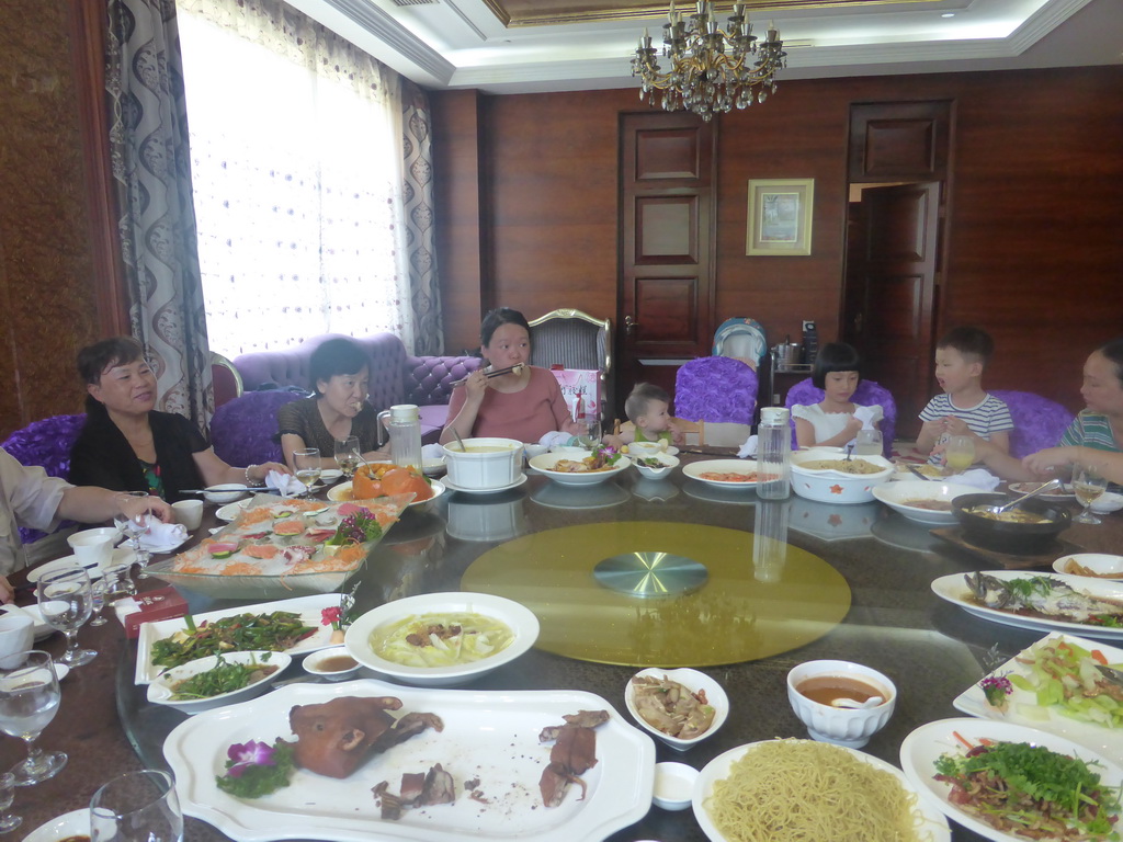 Miaomiao, Max and Miaomiao`s family in the Jinghao Restaurant at Bailong South Road