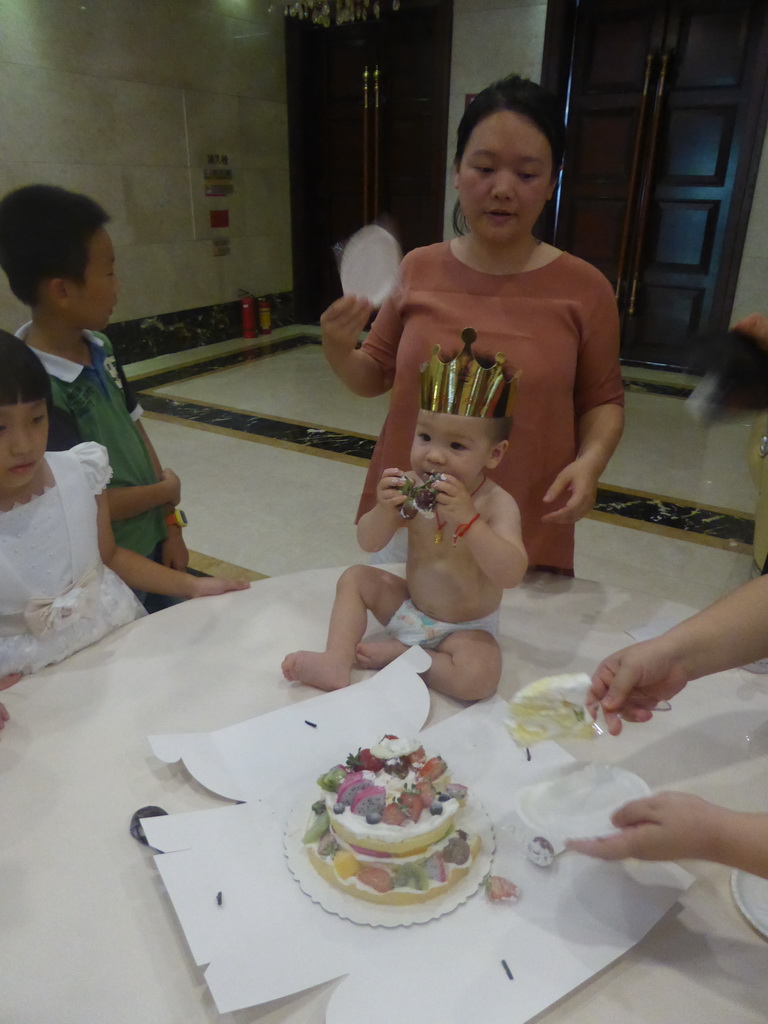 Miaomiao, Miaomiao`s family and Max eating his birthday cake in the Jinghao Restaurant at Bailong South Road