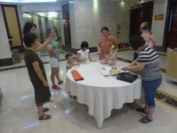 Miaomiao, Miaomiao`s family and Max eating his birthday cake in the Jinghao Restaurant at Bailong South Road