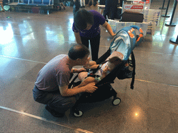 Max and Miaomiao`s parents in the Departures Hall of Haikou Meilan International Airport