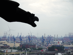 Gargoyle at the tower of the St. Nikolai Memorial, with a view on the Hamburg harbour