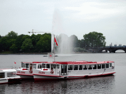 Boats and the Alster Fountains at the Binnenalster lake, viewed from the Ballindamm street