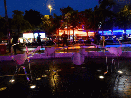 The Beatles Platz square with a steel statue of the Beatles, and the Reeperbahn street, by night