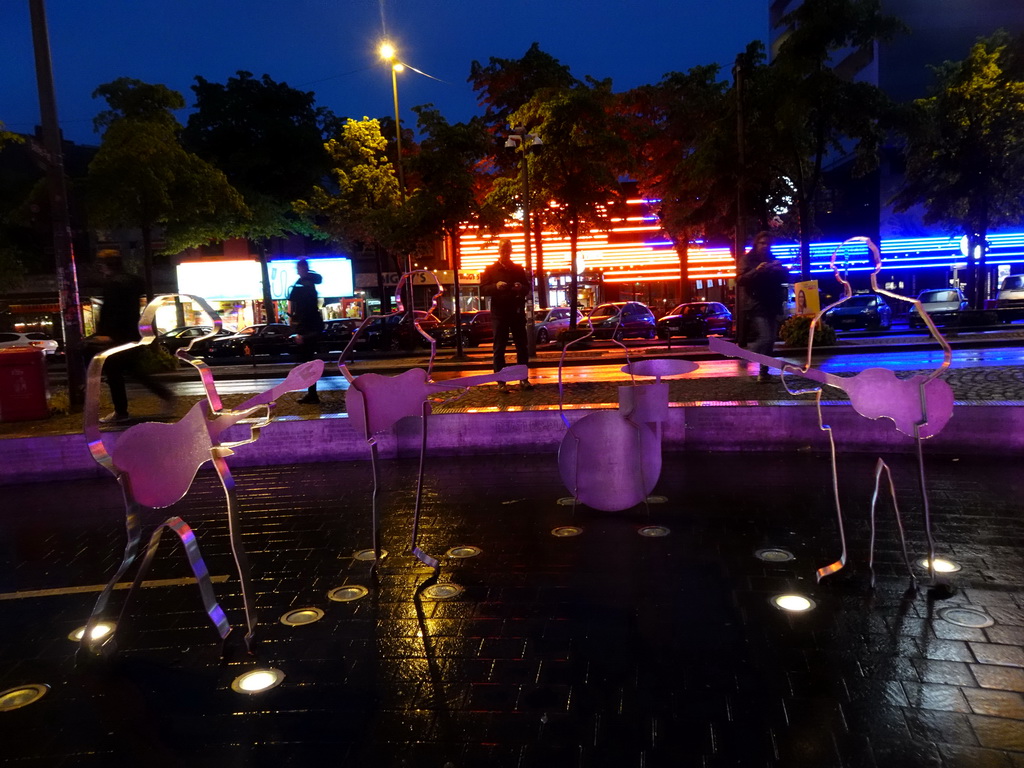 The Beatles Platz square with a steel statue of the Beatles, and the Reeperbahn street, by night