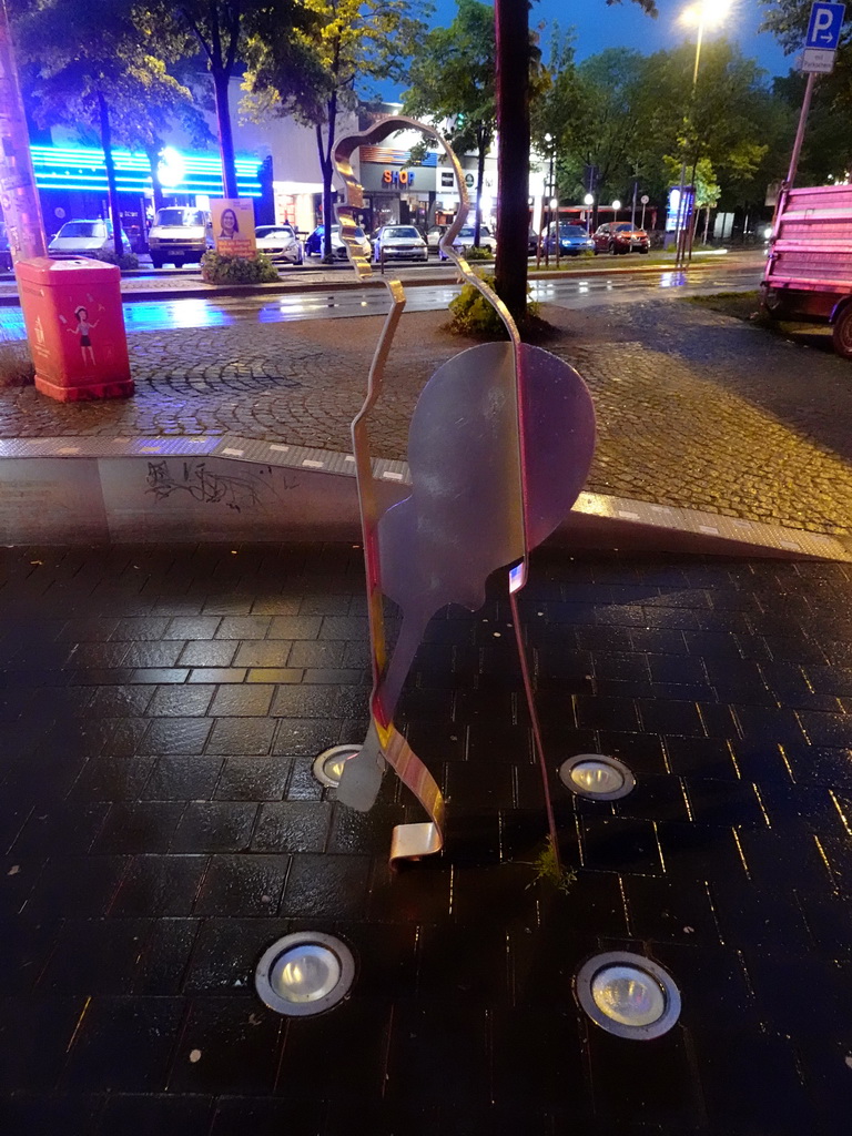 The Beatles Platz square with a steel statue of the Fifth Beatle, and the Reeperbahn street, by night