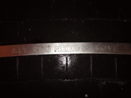 `All You Need Is Love` carved in stone at the Beatles Platz square, by night