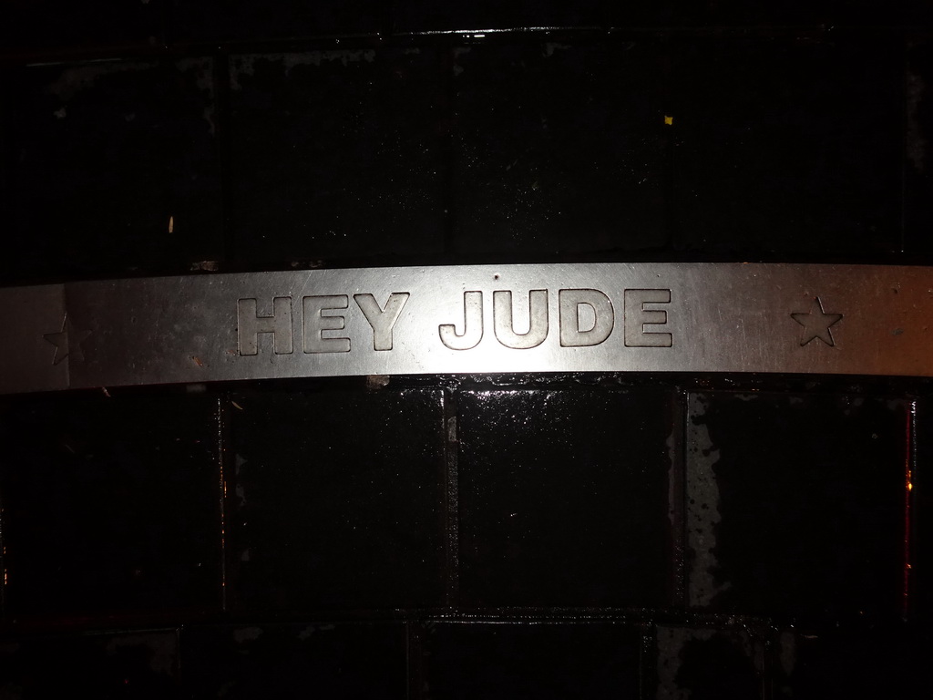 `Hey Jude` carved in stone at the Beatles Platz square, by night