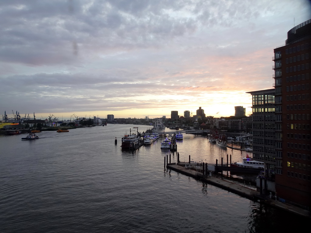 Boats in the Elbe river, the Niederhafen harbour and the St. Pauli Piers, viewed from the viewing window of the Elbphilharmonie concert hall, at sunset