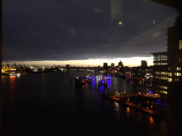 Boats in the Elbe river, the Niederhafen harbour and the St. Pauli Piers, viewed from the viewing window of the Elbphilharmonie concert hall, by night