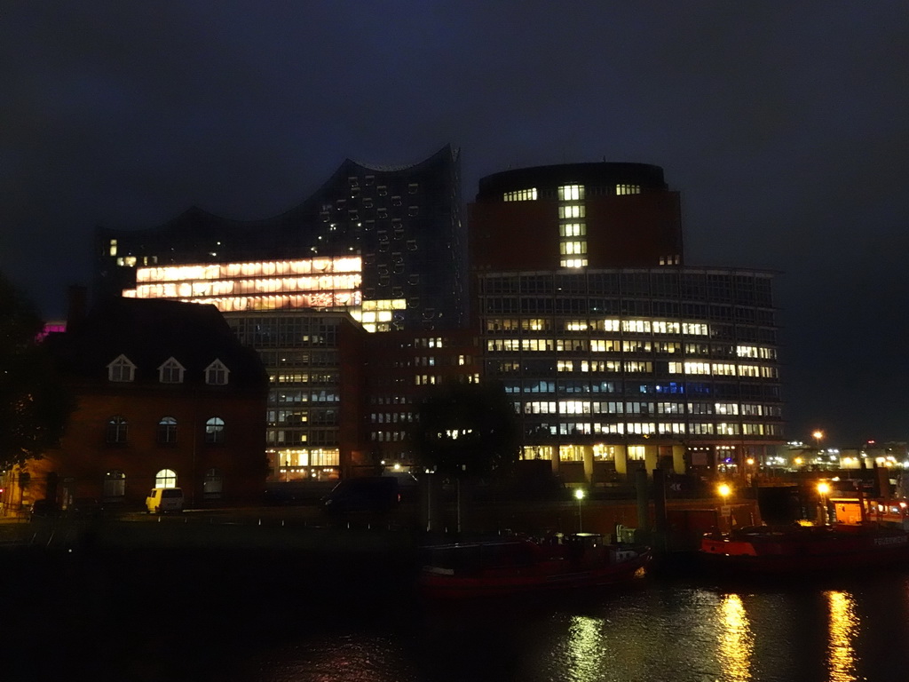 The Niederhafen harbour, the Elbe river, the Harbor Police Station No. 2, the Kehrwiederspitze building and the Elbphilharmonie concert hall, viewed from the Elbpromenade, by night