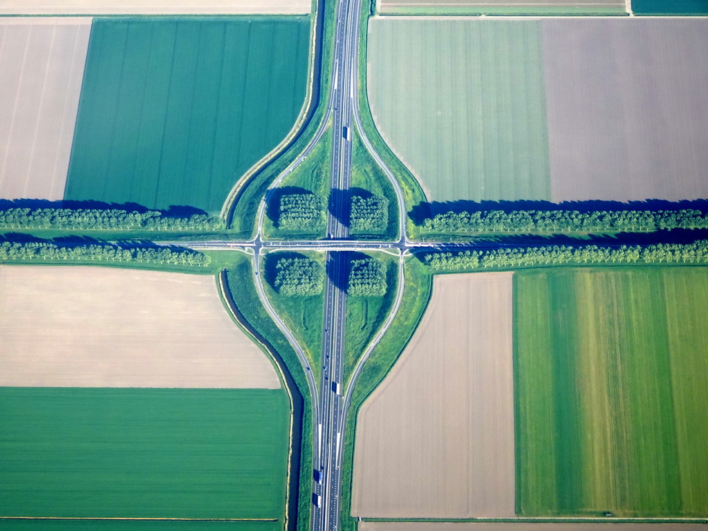 The crossing of the A27 highway and the Vogelstraat street at the east side of the city of Almere, viewed from the airplane to Amsterdam