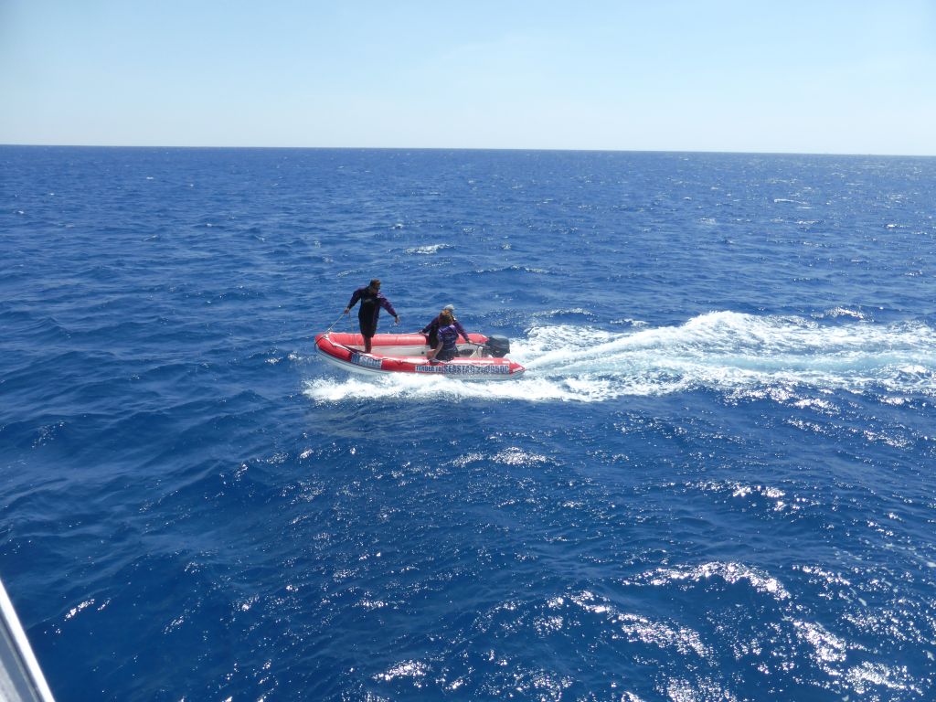 Small boat with tour guides, viewed from our Seastar Cruises tour boat