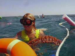 Tour guide with Sea Cucumber and other snorkelers