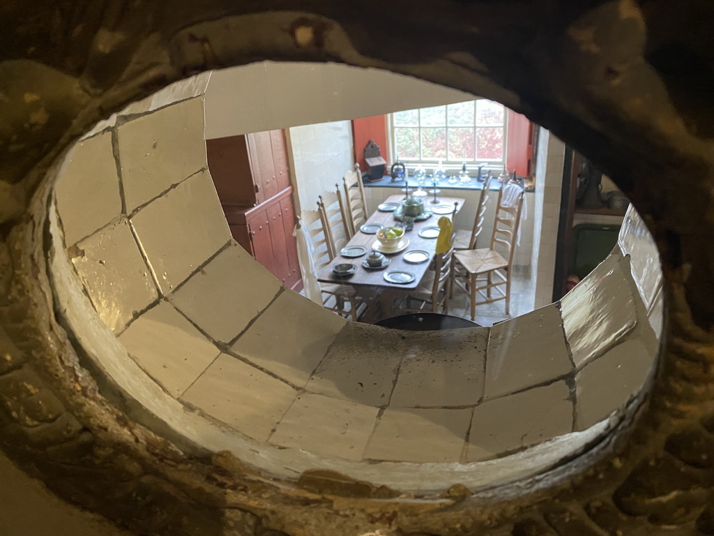 Window at the staircase from the first floor to the ground floor of the main building of the Heeswijk Castle, with a view on the kitchen, during the `Sint op het Kasteel 2022` event