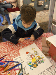 Max with a colouring page at the museum room at the basement of the main building of the Heeswijk Castle, during the `Sint op het Kasteel 2022` event