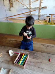 Max playing with pencils and sea shells at the upper floor of the main building of the HistoryLand museum