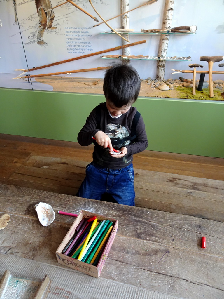 Max playing with pencils and sea shells at the upper floor of the main building of the HistoryLand museum