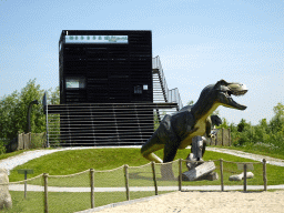 Tyrannosaurus Rex statue at the Dinopark area and the Spiegelzee building at the HistoryLand museum