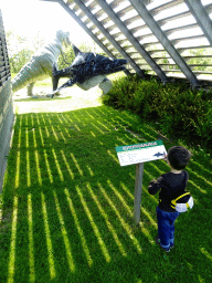 Max with an Ichthyosaurus statue at the Dinopark area at the HistoryLand museum, with explanation