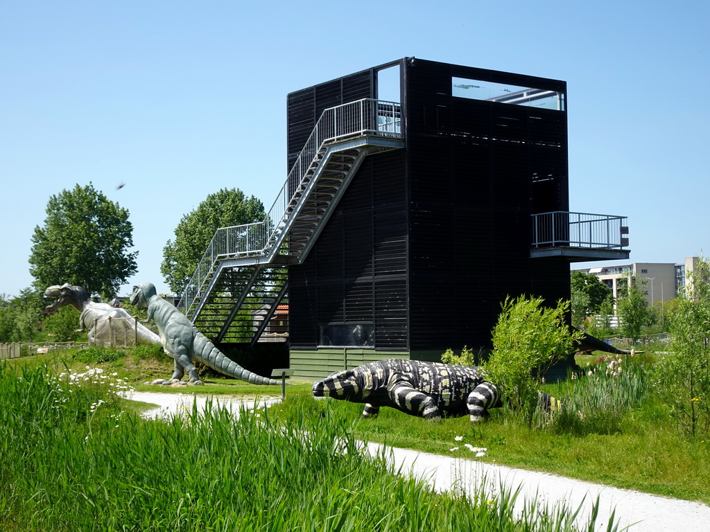 Dinosaur statues at the Dinopark area and the Spiegelzee building at the HistoryLand museum