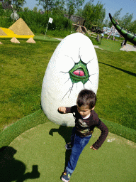 Max with a dinosaur egg statue at the miniature golf course at the HistoryLand museum