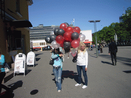 Miaomiao`s colleagues with balloons at the Tennispalatsinaukio square