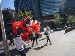 Miaomiao`s colleagues with balloons at the Tennispalatsinaukio square