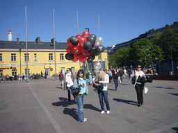 Miaomiao`s colleagues with balloons at the Tennispalatsinaukio square