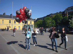 Miaomiao`s colleagues with balloons at the Tennispalatsinaukio square