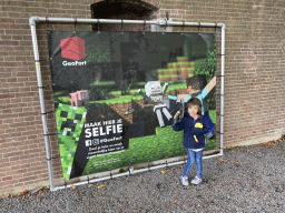 Max with a Minecraft poster in front of Building A at the GeoFort