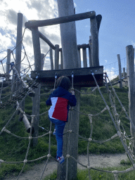 Max climbing on a rope bridge at the Bat Playground at the GeoFort