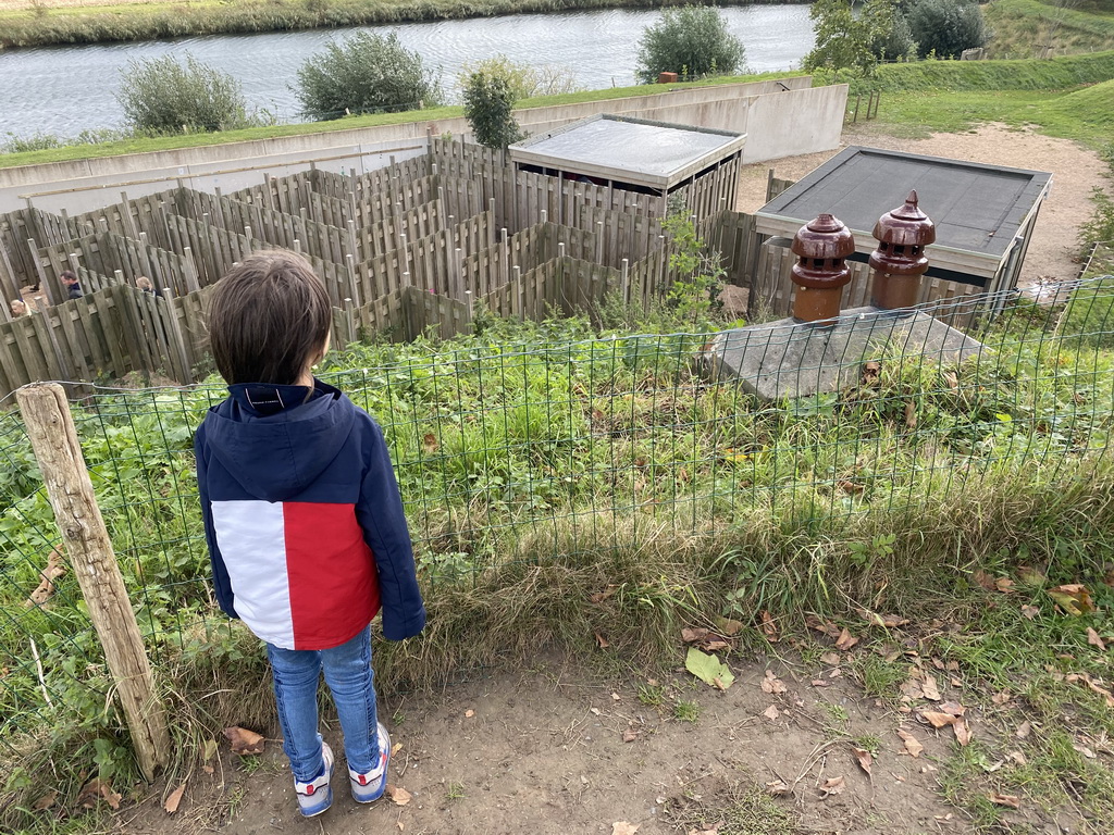 Max on the hill at the GeoFort, with a view on the Salmon Maze and the Elements Maze