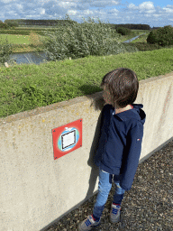 Max with a sign of the Climate Quest attraction at the GeoFort