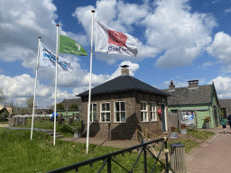 Flags and small building in front of the GeoFort Wereld pancake restaurant at the GeoFort