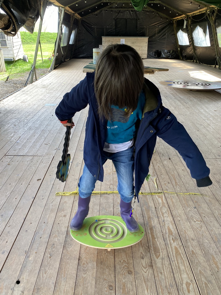 Max with a Minecraft axe doing the small balance game at the Krayenhoff Tent at the GeoFort