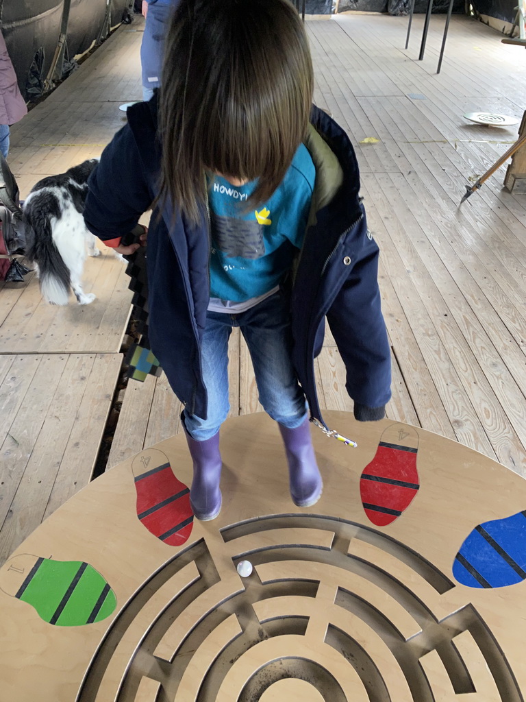 Max with a Minecraft axe doing the large balance game at the Krayenhoff Tent at the GeoFort