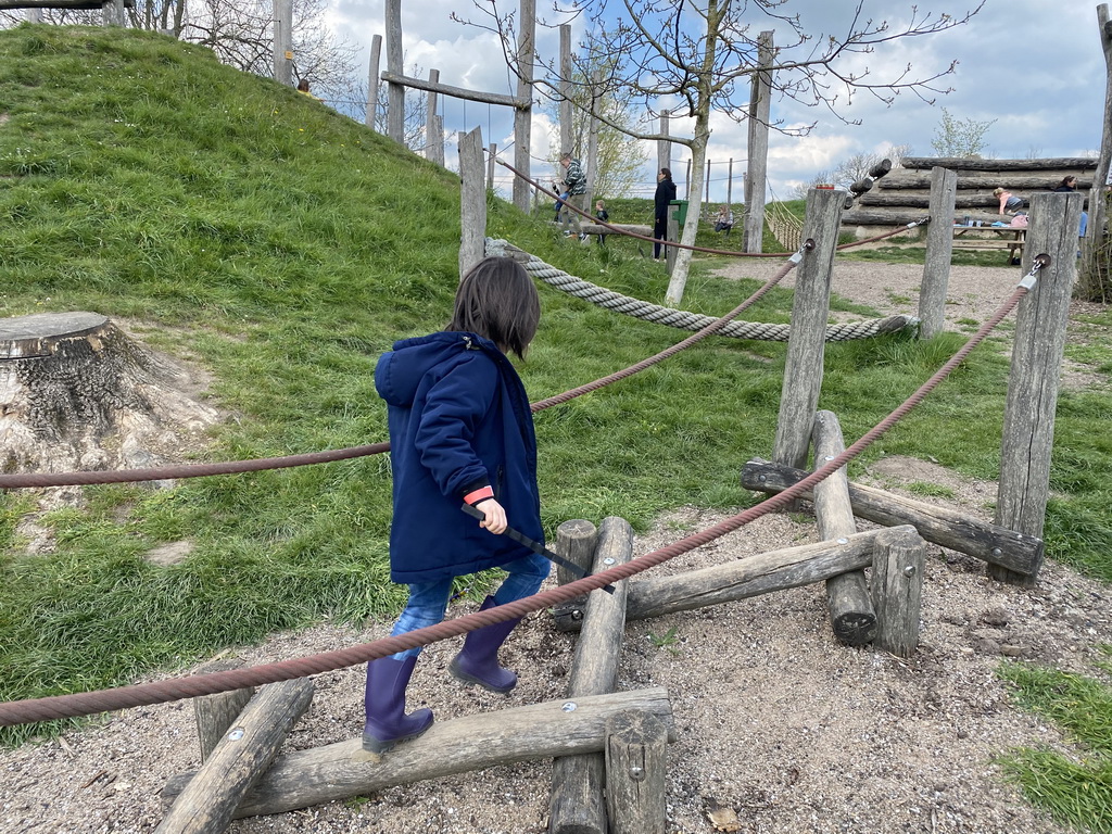 Max with a Minecraft axe on a rope bridge at the Bat Playground at the GeoFort