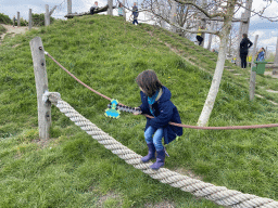 Max with a Minecraft axe on a rope bridge at the Bat Playground at the GeoFort