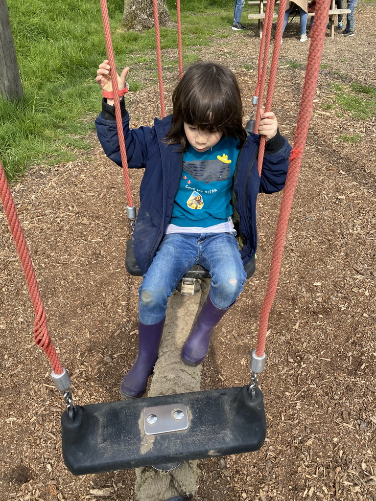 Max on a swing at the Bat Playground at the GeoFort