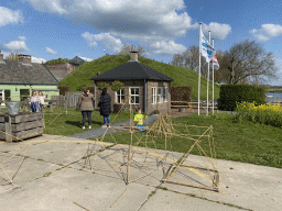 Stick houses and small building in front of the GeoFort Wereld pancake restaurant at the GeoFort