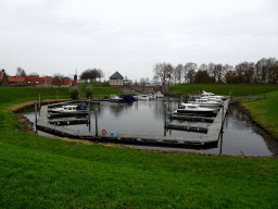 Boats and bridge at the De Wiel lake, the Boei35 restaurant and Windmill nr. II, viewed from the south side