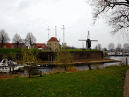 The east side of the Stadshaven harbour, the Veerpoort gate and Windmill nr. II, viewed from the Wieldijk street