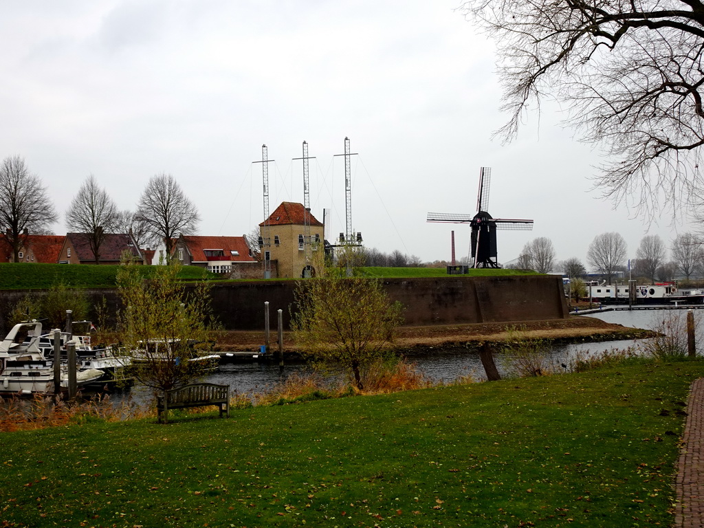 The east side of the Stadshaven harbour, the Veerpoort gate and Windmill nr. II, viewed from the Wieldijk street