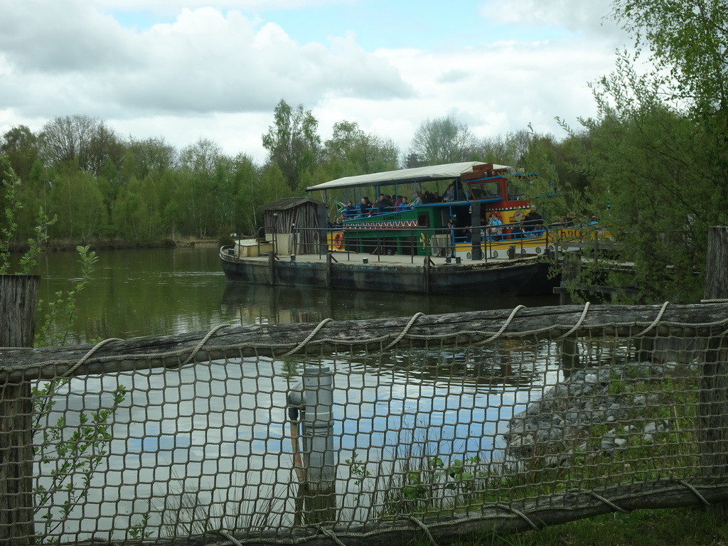 Safari boat leaving from the Safariplein square at the Safaripark Beekse Bergen, viewed from the car during the Autosafari