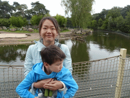 Miaomiao and Max at the Kongoplein square at the Safaripark Beekse Bergen, with a view on the Hippopotamuses