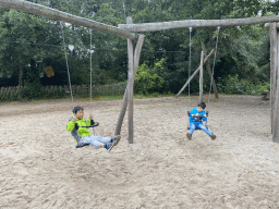 Max and his friend on a swing at the playground of the Afrikadorp village at the Safaripark Beekse Bergen