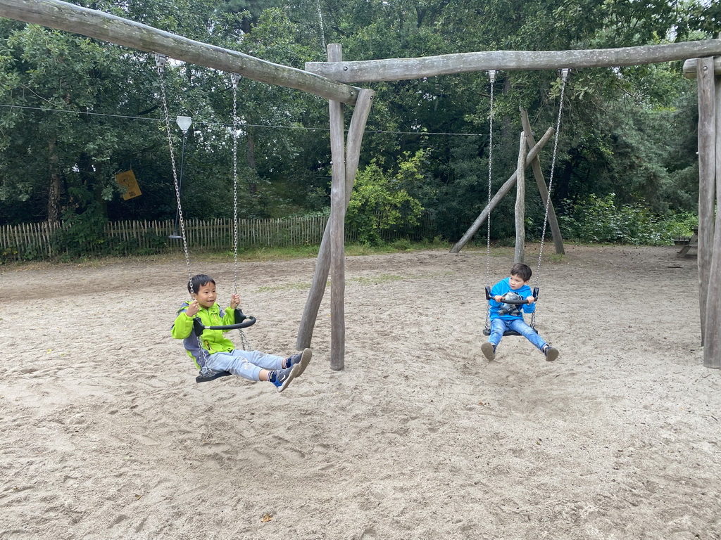 Max and his friend on a swing at the playground of the Afrikadorp village at the Safaripark Beekse Bergen